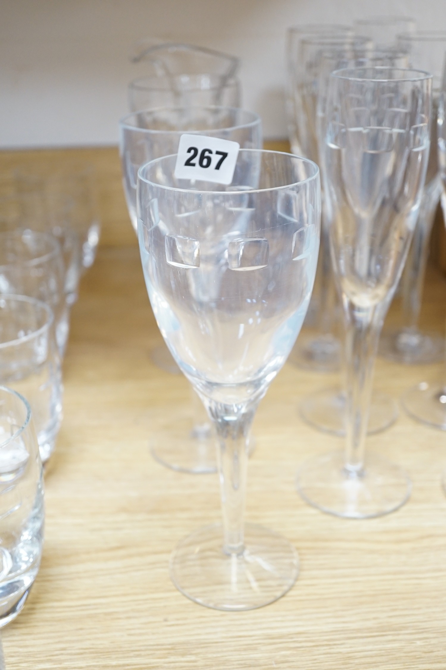 John Rocha for Waterford. A set of 8 cut glass flutes with six matching tumblers, three goblets and a carafe